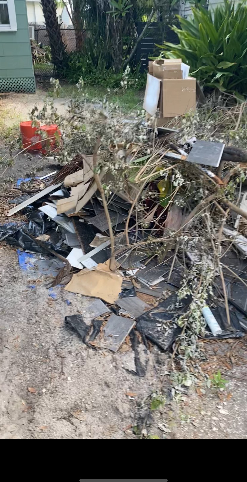 Pile of construction debris and yard waste before removal